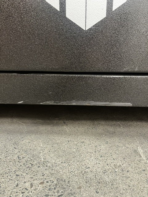 View of the bottom edge of the safe where is some scratches.  