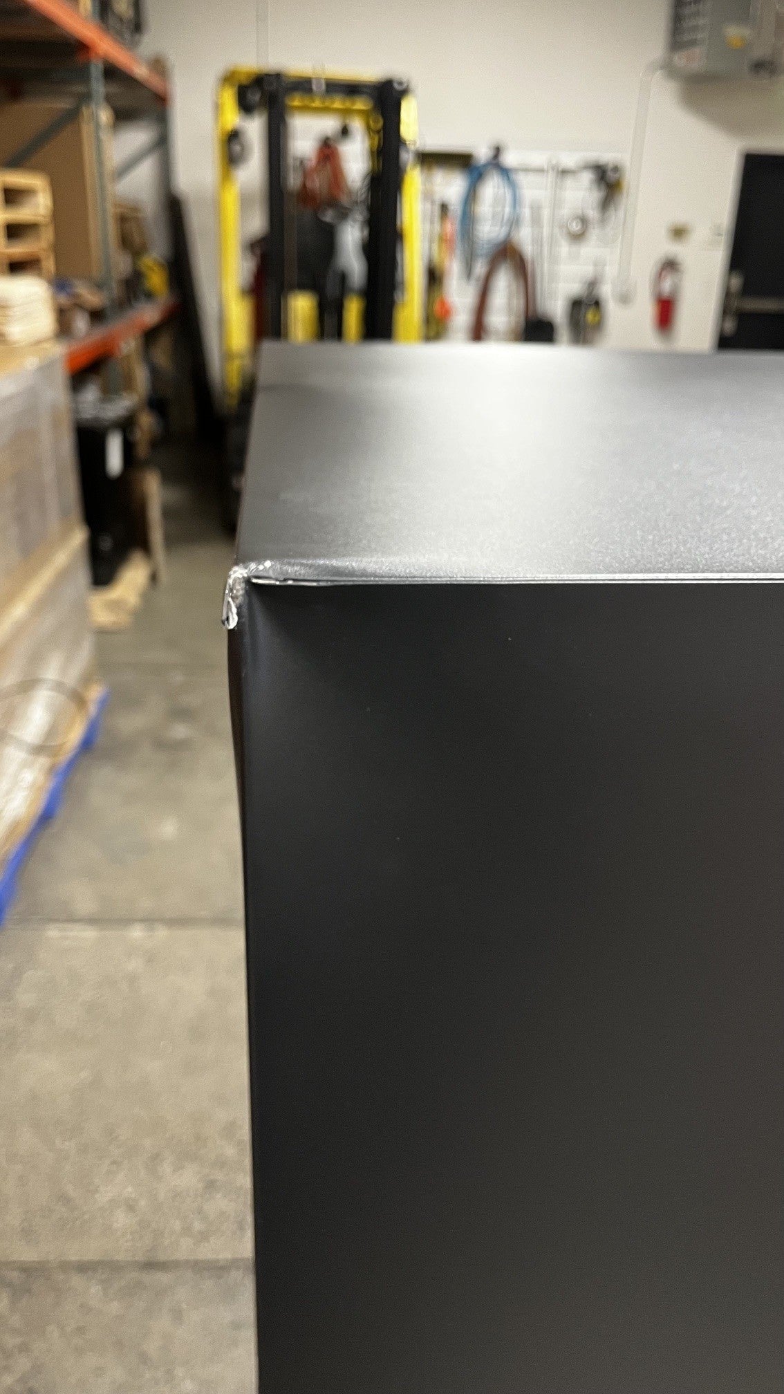 Close-up view of the dent and chip on the top left corner. 