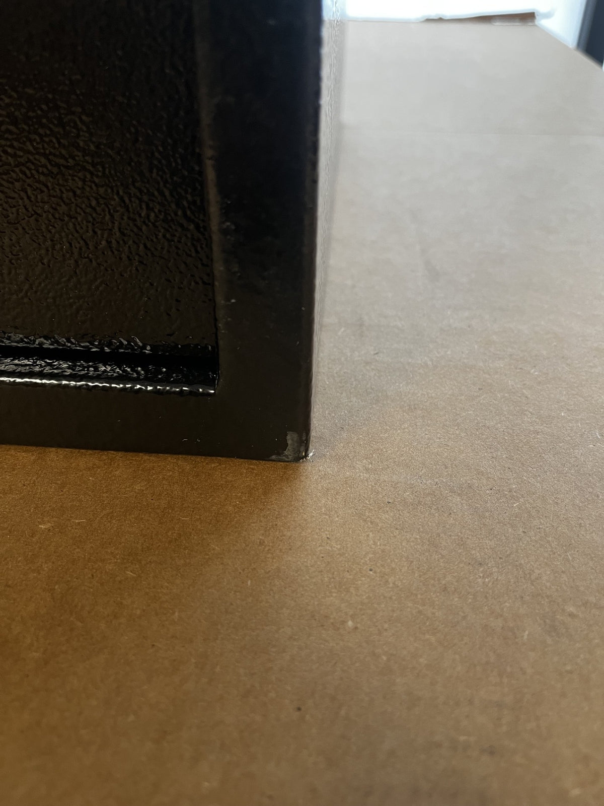 View of a small paint chip on the bottom right corner of the safe. 