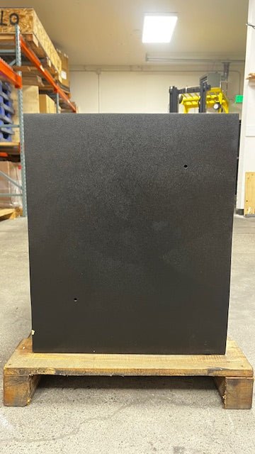 View of the back of the safe. The safe comes with 2 predrilled holes to pass power inti the safe. The lower left side has a chip on the paint. 