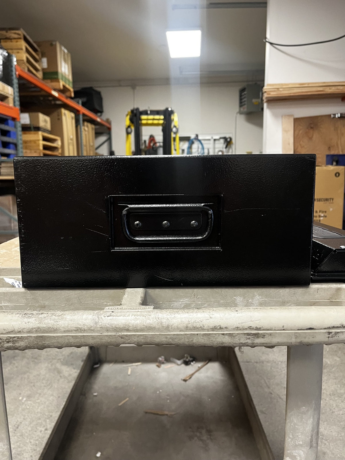 View of the right side of the safe. The body has a few scratches on it. 