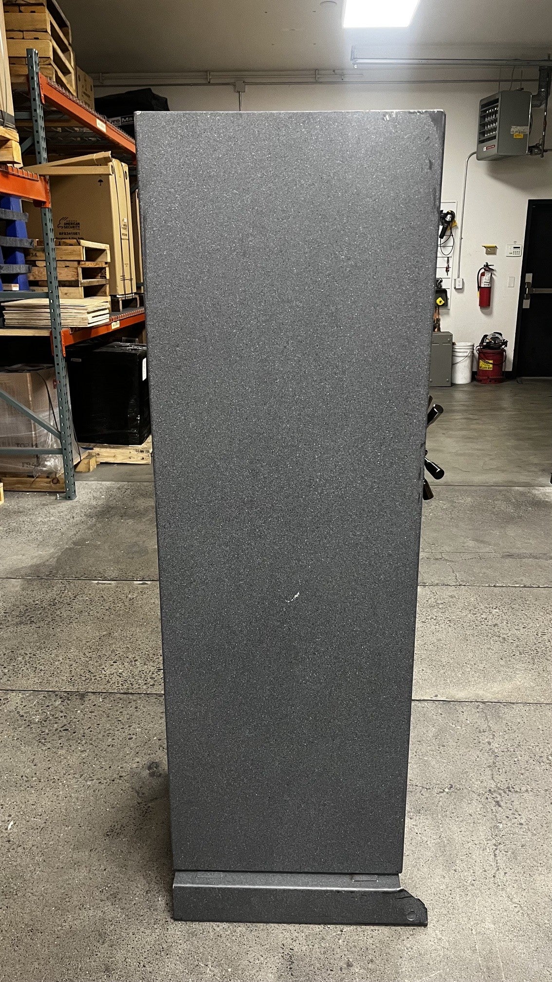 View of the left side of the safe. The top right corner has a few scratches on it. 