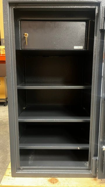 Close-up view of the inside of the safe. A few of the shelves have some chips on the paint. It comes with two keys for the interlocker. 