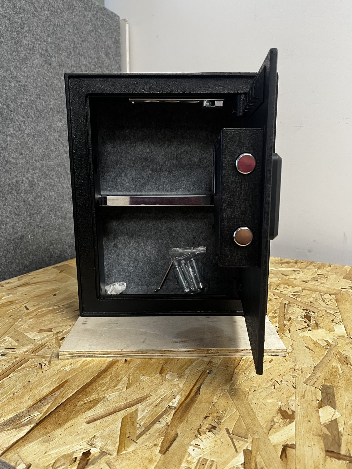 View of the inside of the safe. It has one adjustable shelf. It also comes with the hardware. 