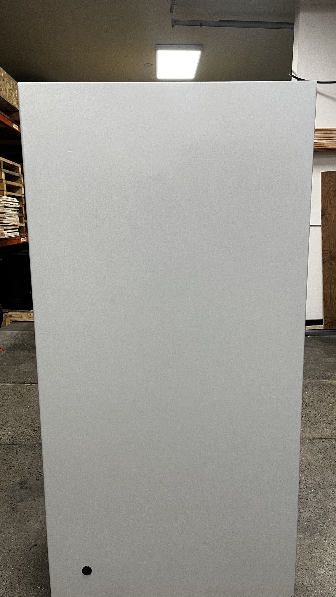 View of the backside of the safe. It has a predrilled hole on the bottom to pass a power cable into the safe. 