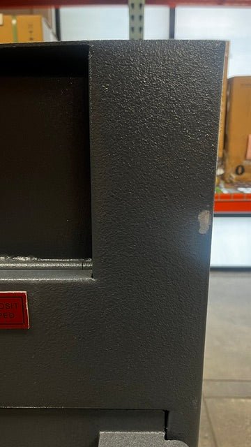 Close-up view of the paint chip on the right edge of the safe.
