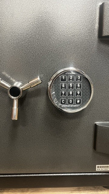 Close-up view of the digital lock. It has a chrome finish. 