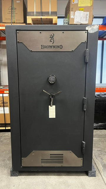 Front view of the safe, the safe has a dent and is missing paint on the top right corner. The metal plates have a few scratches as well. 