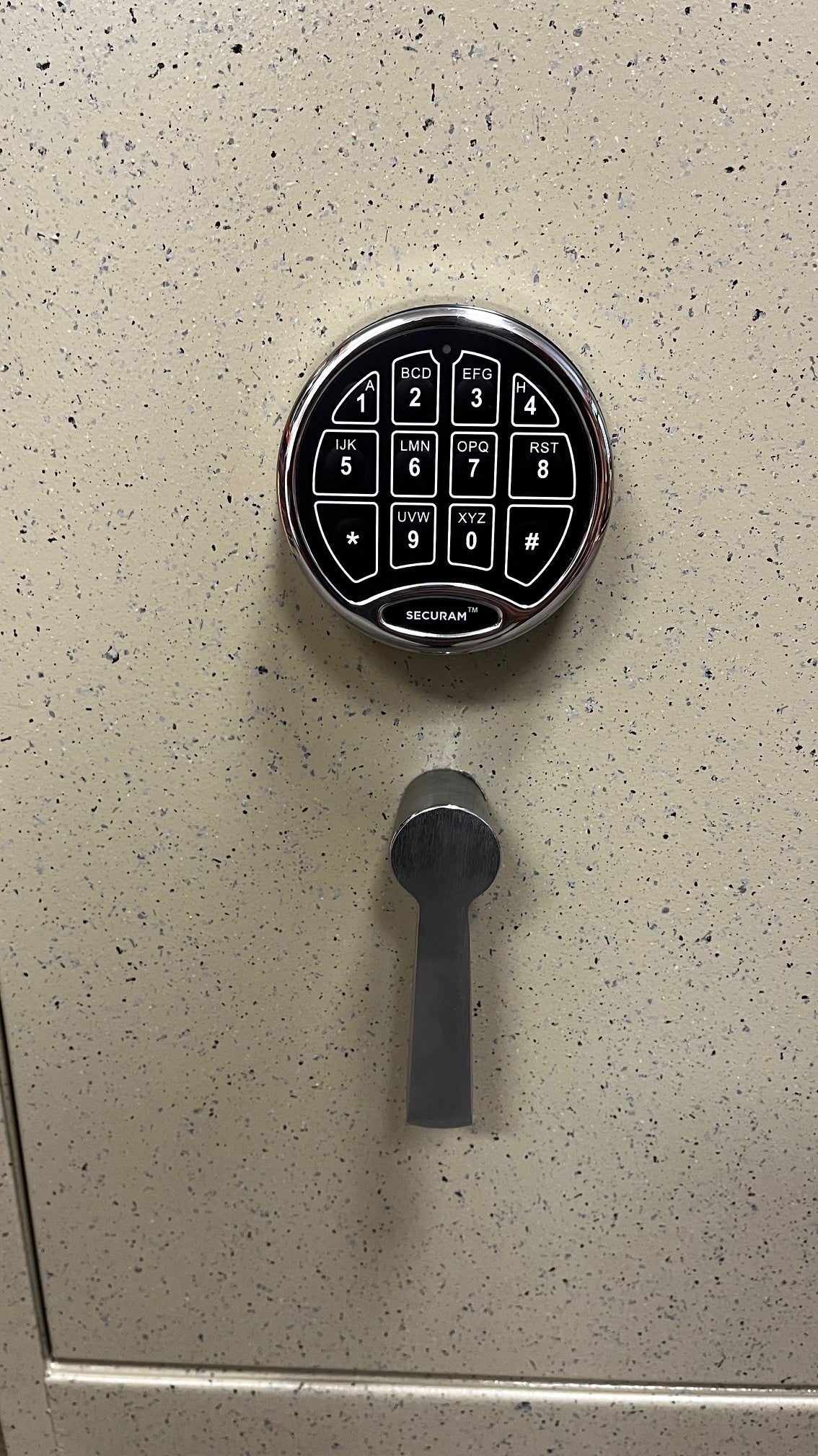 Close-up of the sliver handle and sliver digital lock. The manufacture of the digital lock is Securam. 