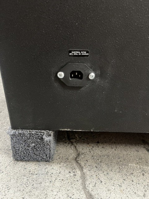 Close-up view of the outlet and small paint chips on the edge of the bottom of the safe. 