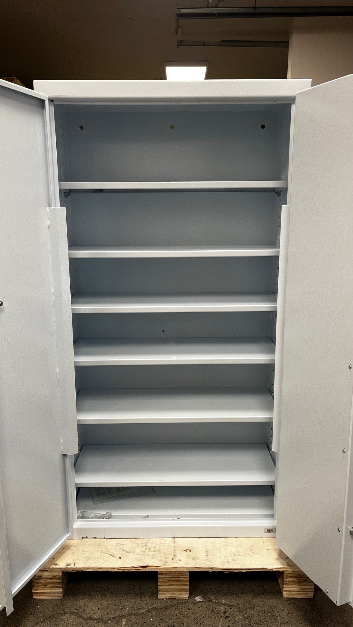 View of the safe with the doors open, the safe comes with 7 shelves but only 6 are in the picture. The safe also had predrilled holes on the top to making it able to be drilled onto a wall. 