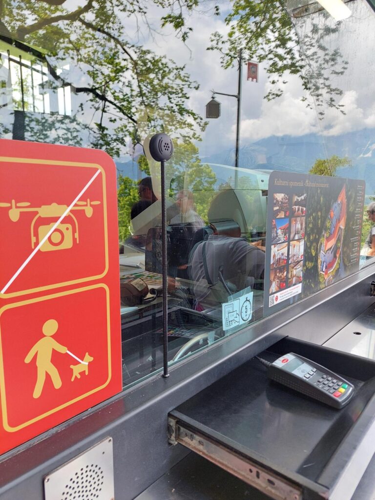 Contacta stem microphone at an outdoor payment window at a mountain attraction with payment terminal below