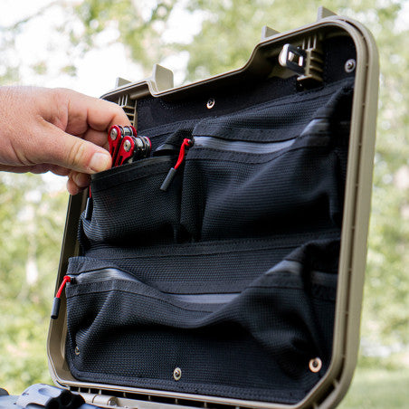 Hand reaching into the Vaultek XE-ON1 lid organizer installed inside a LifePod XE to grab a multi-tool