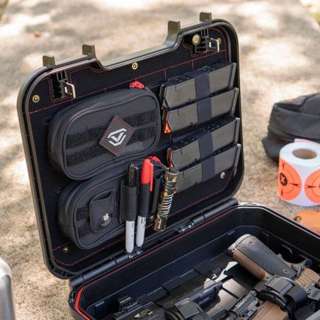 Vaultek LifePod XE open at an outdoor range with the XE-RK Range Kit installed in the lid and a handgun in the interior