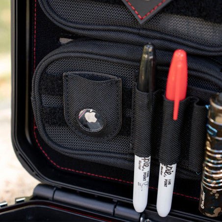 Close-up of the Vaultek XE-RK AirTag pocket holding an Apple AirTag beside the 3-slot organizer with markers and tools