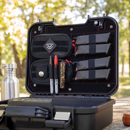 Vaultek LifePod XE open on a picnic table outdoors with the XE-RK Range Kit holding mags, markers, and an AirTag pocket