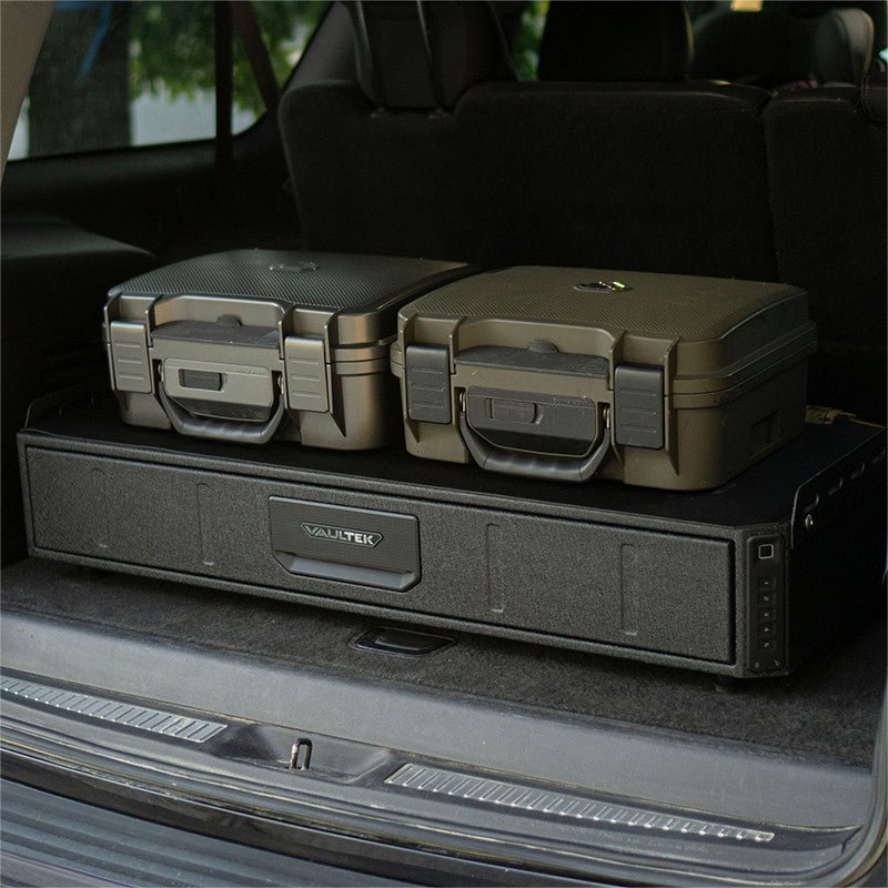 Vaultek SLV200i in an SUV cargo area with two tactical cases stored on the top deck storage area