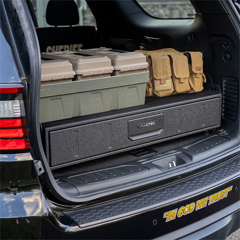 Vaultek SLV200i installed in a sheriff’s patrol SUV cargo area with military ammo cans stored on the top deck