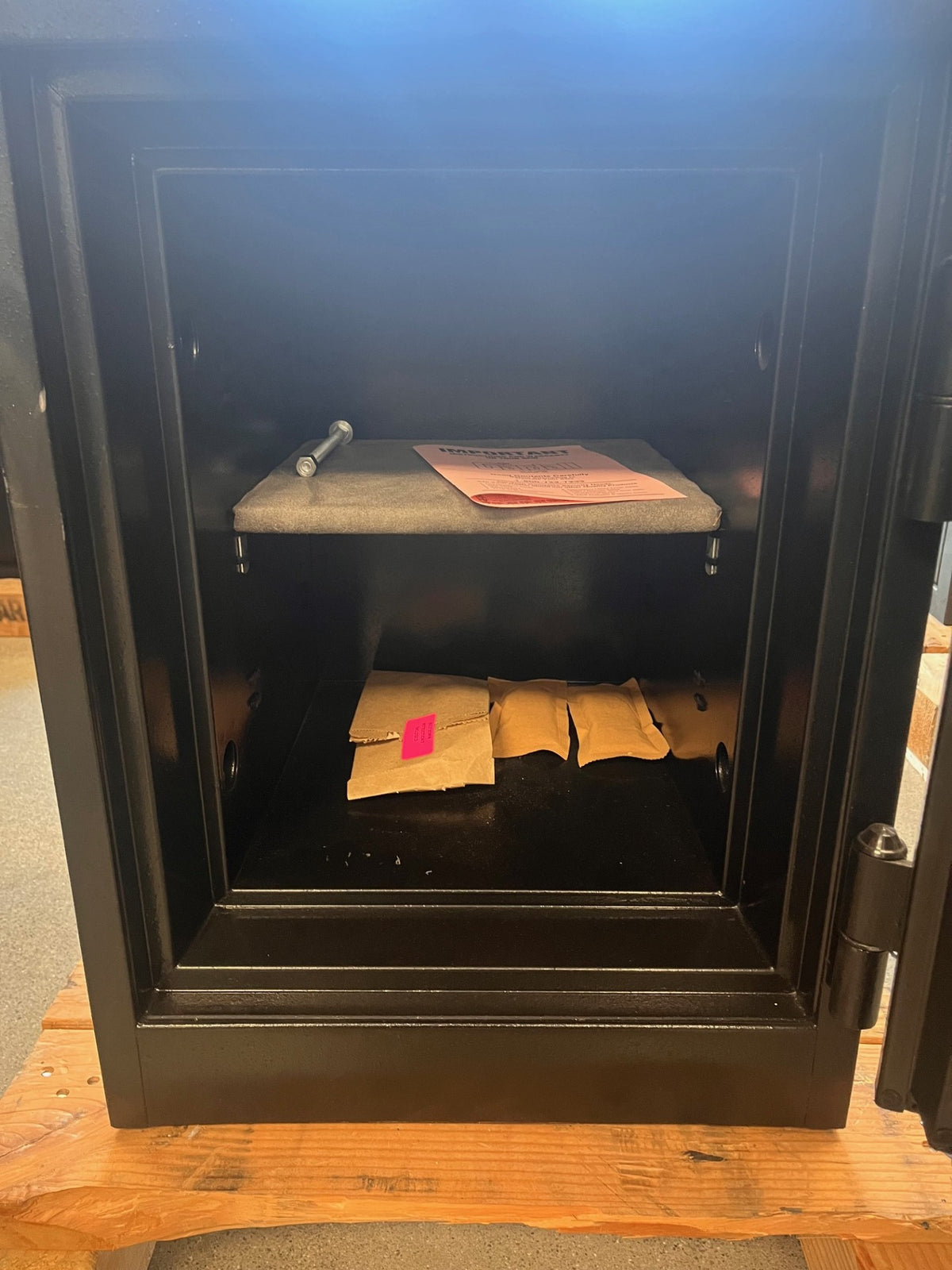 Close up view of the inside of the safe with one shelf that is adjustable. 