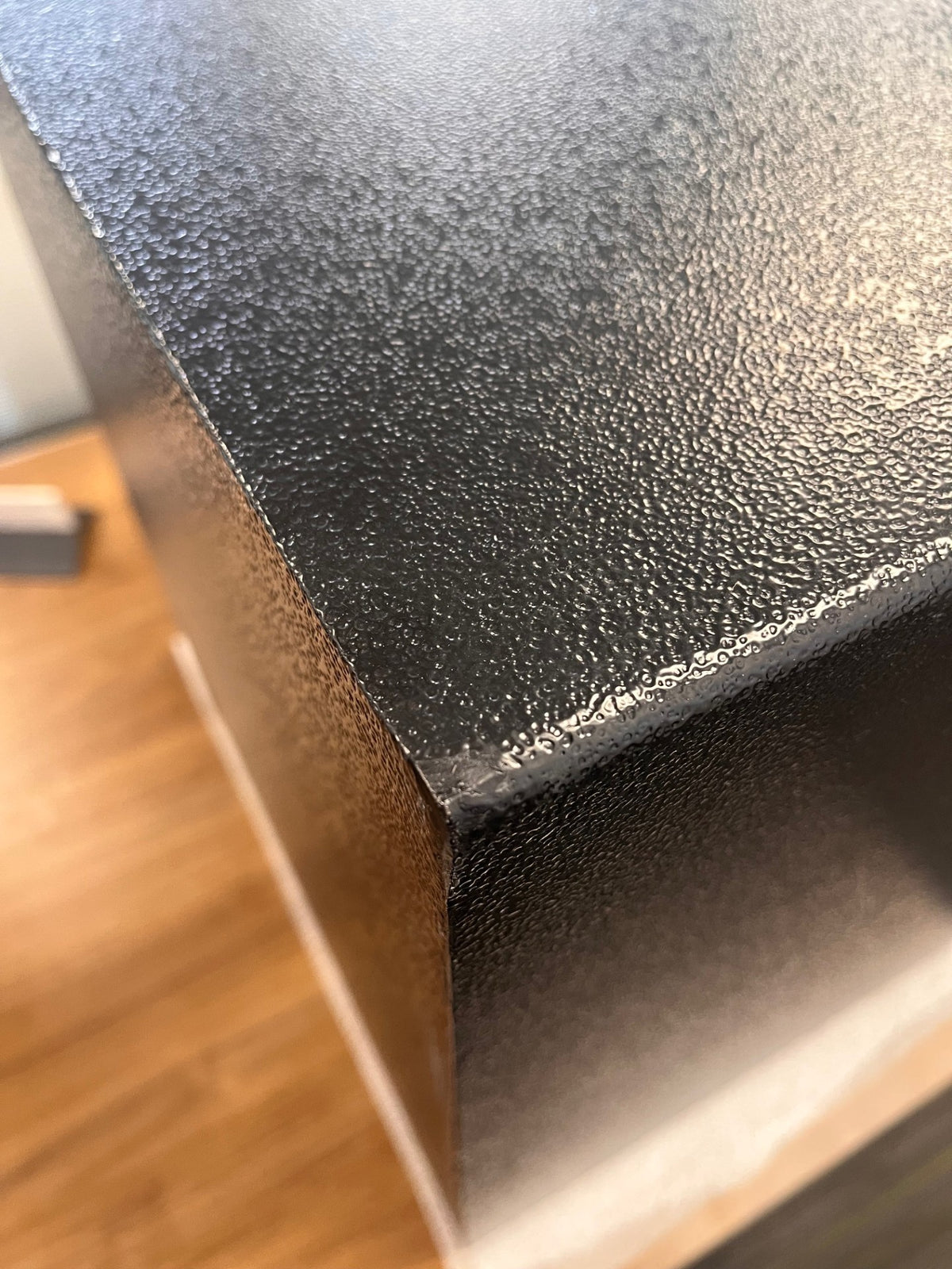 Top back left corner with a small scratch. 