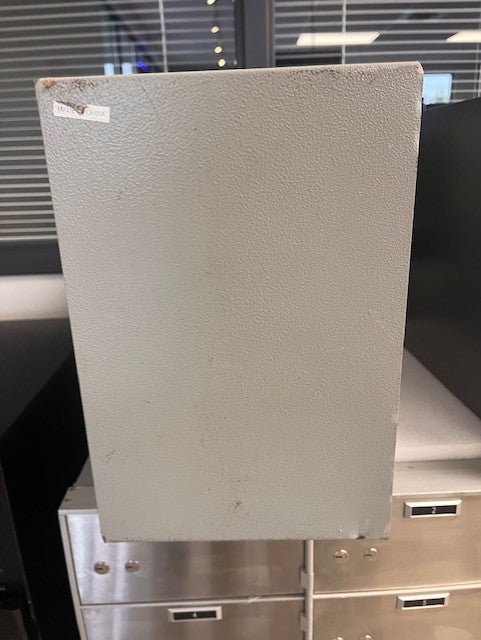 Back view of the safe. It has some blemished alongside the edges.