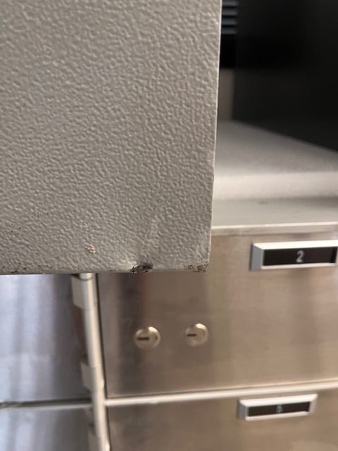 Bottom left corner has a dent and a chip.