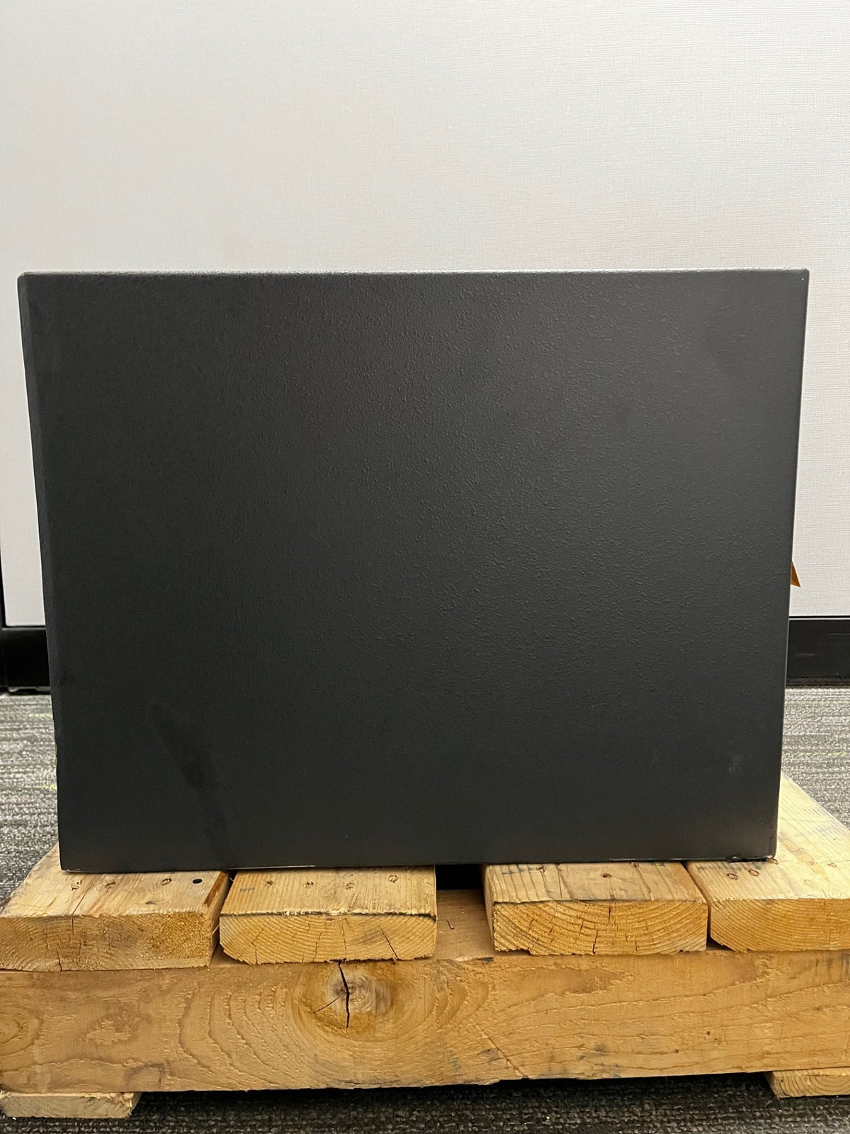 Left side view of the safe. It has some scratches on the bottom edge.