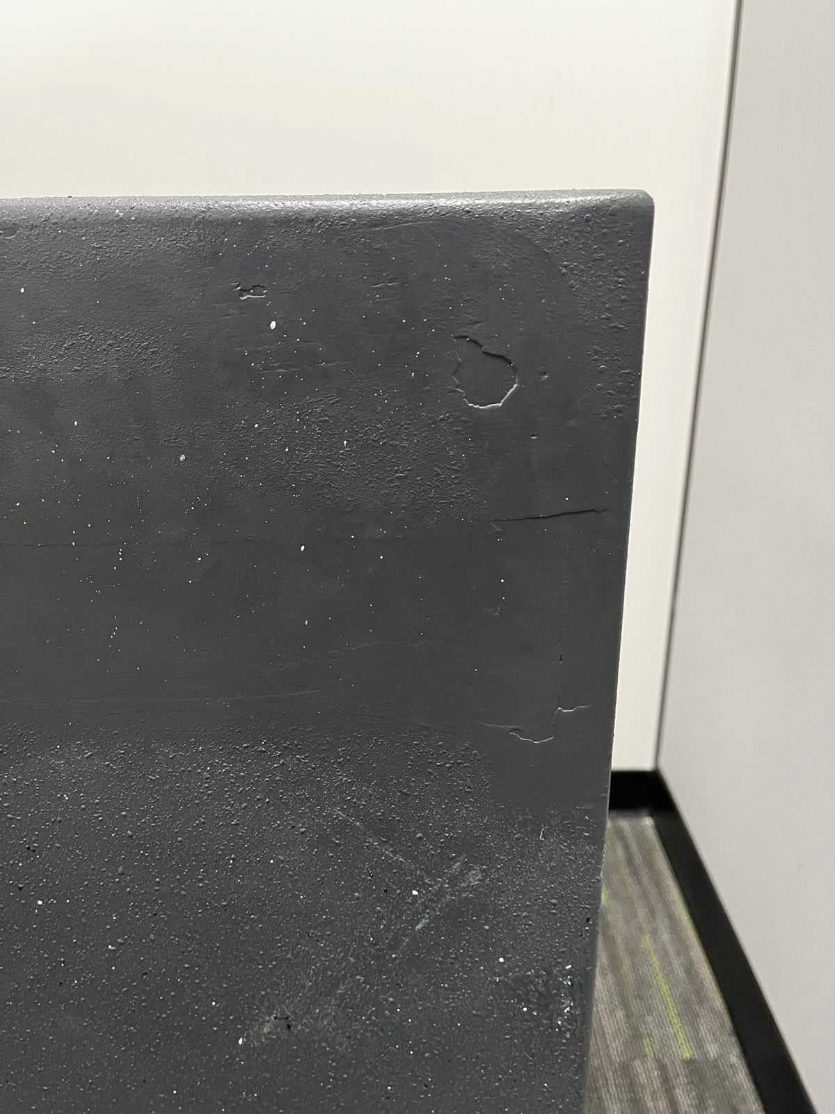 Close-up of the top back of the safe. It has a few scratches which have been painted over with. 