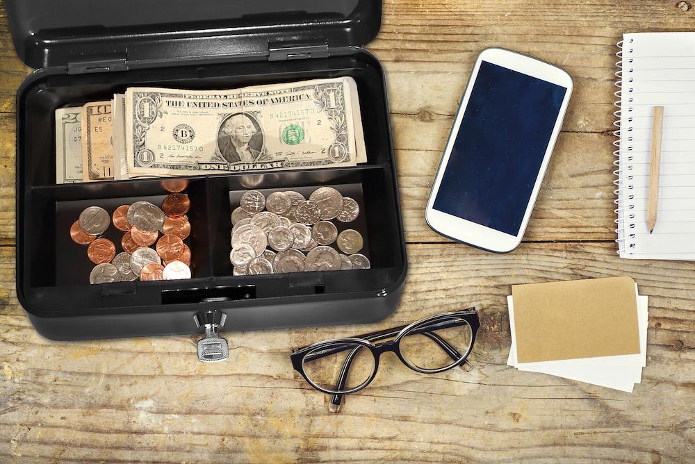 Honeywell 6202 Steel Cash Box with Key Lock & Removable Coin Tray on Desk with Phone and Glasses